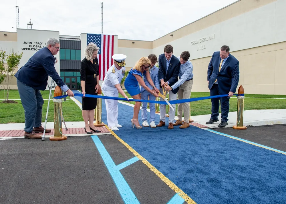 The Hefti family joins Admiral Daryl Caudle and Representative Jen Kiggans for the ribbon cutting at the John Bag Hefti Global LVC Operations Center
